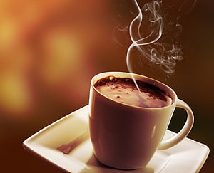 Steaming White Ceramic Cup of Hot Coffee on a Square Saucer with Warm Golden Background HD wallpaper