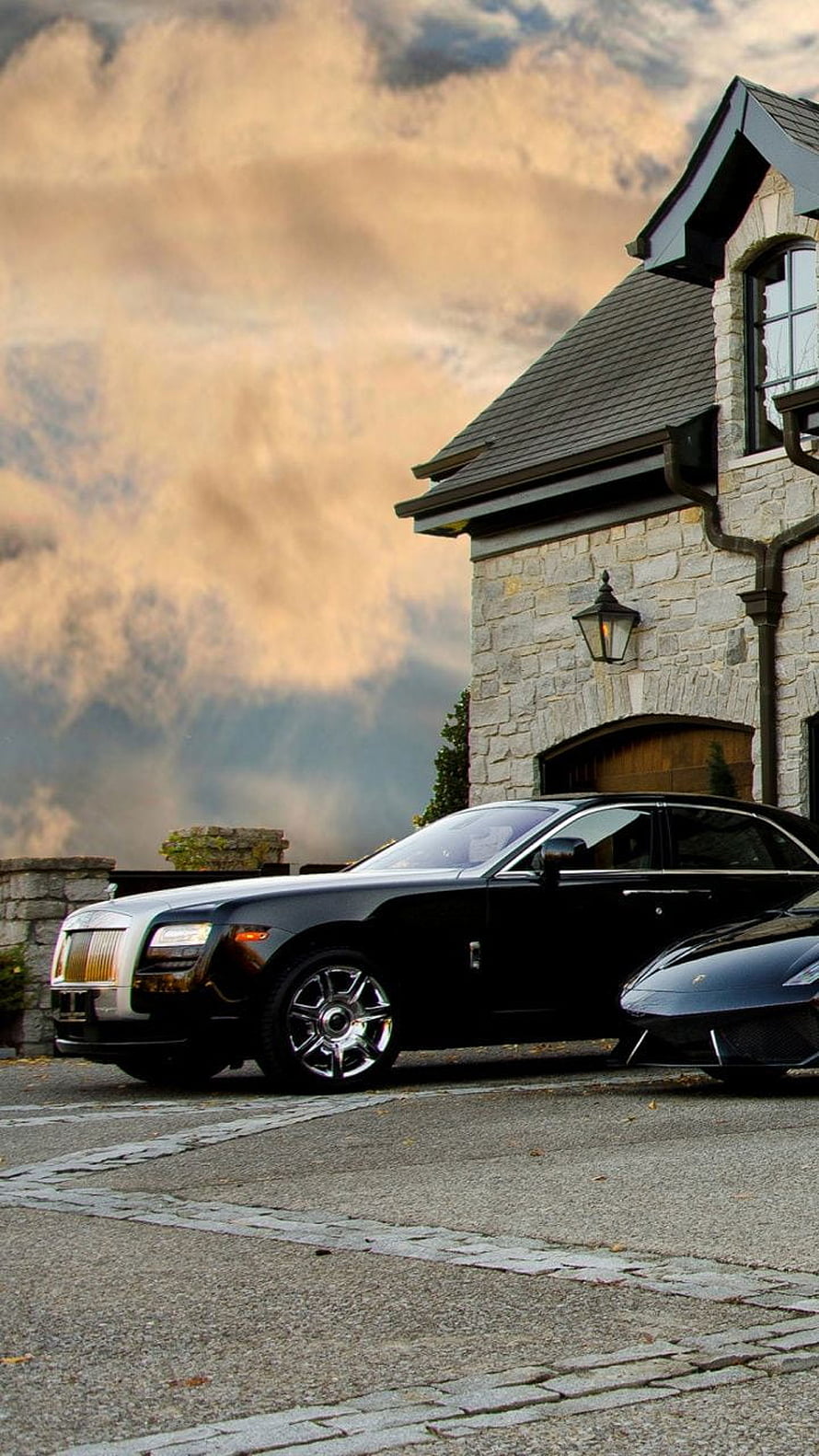 Black Rolls-Royce Ghost Parked in Front of a Luxury Stone Mansion at Dusk HD phone wallpaper