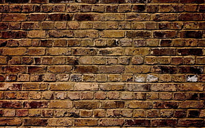 Rustic Weathered Brick Wall Texture with Warm Earthy Tones and Aged Surface Details HD wallpaper