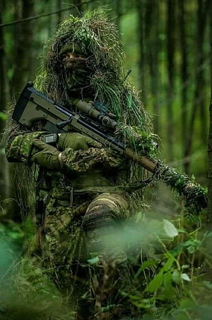Sniper in Ghillie Suit Holding Rifle in Dense Forest Camouflage HD phone wallpaper