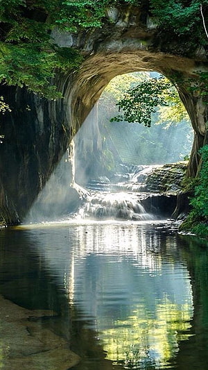 Natural Rock Arch Overlooking Misty Waterfall and Calm Forest Pool HD phone wallpaper