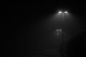 Moody Street Lights Cutting Through Thick Fog on a Dark Night Road HD wallpaper