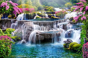 Springtime cascading waterfall surrounded by vibrant pink blossoms and lush green foliage HD wallpaper