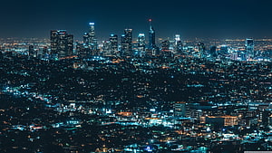Aerial Night View of a Modern City Skyline with Glowing Skyscrapers and Urban Lights HD wallpaper