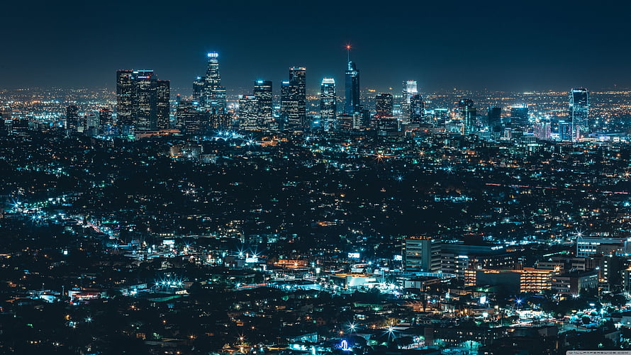 Aerial Night View of a Modern City Skyline with Glowing Skyscrapers and Urban Lights HD wallpaper