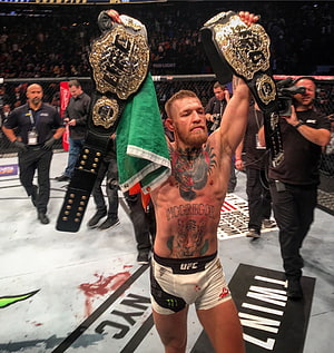 Conor McGregor Celebrates UFC Double Championship Victory in the Octagon HD phone wallpaper