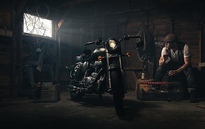 Royal Enfield motorcycle parked in a dimly lit rustic garage with a man smoking nearby, Royal Enfield, garage, bike, motorcycle HD wallpaper