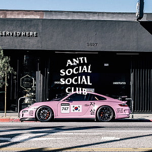 Pink Porsche 911 with Anti Social Social Club Livery Parked on Urban Street HD wallpaper