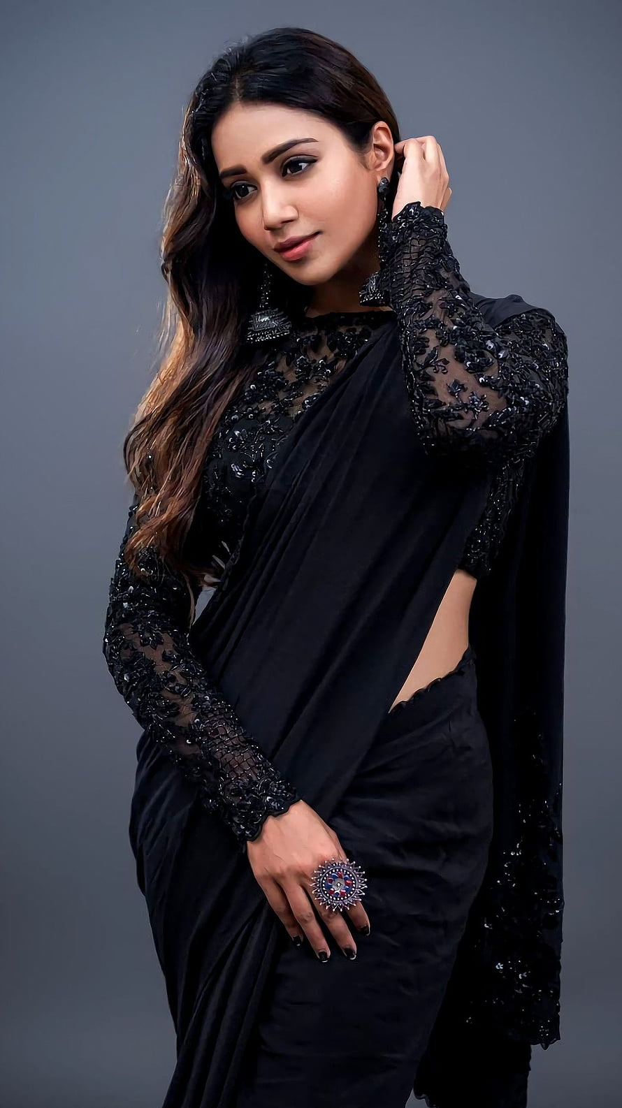 Nivetha Thomas in an elegant black embroidered saree with statement jewelry HD phone wallpaper