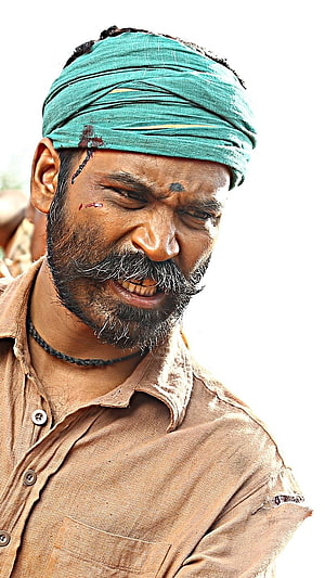 Dhanush in a gritty action role wearing a green turban and a weathered brown shirt HD phone wallpaper