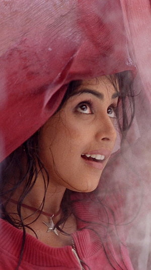Genelia D'Souza in a red hooded jacket with a star pendant necklace HD phone wallpaper