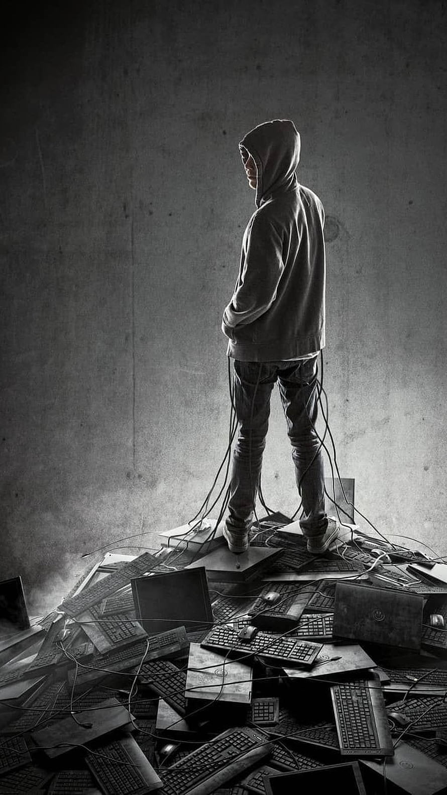 Hacker Standing on Pile of Keyboards and Laptops in Dark Room HD phone wallpaper