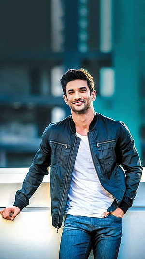 Sushant Singh Rajput in Black Bomber Jacket and White Tee Against Urban Backdrop HD phone wallpaper