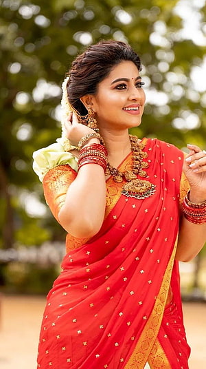 Sneha in a vibrant red and gold saree with traditional jewelry and floral hair accessory HD phone wallpaper