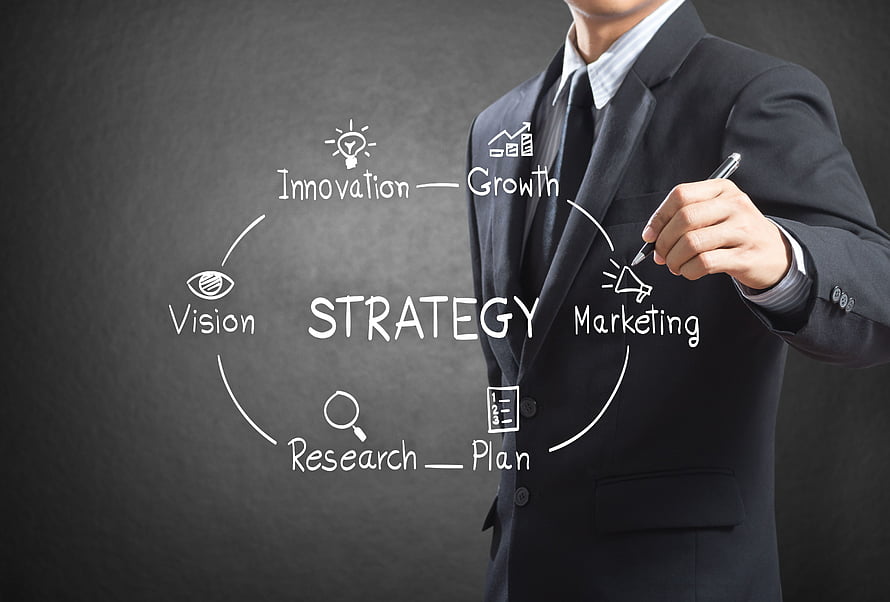 Businessman in suit sketching a business strategy diagram with vision, innovation, and growth concepts on a dark background HD wallpaper