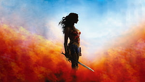 Wonder Woman warrior silhouette standing in fiery orange smoke against a blue sky HD wallpaper