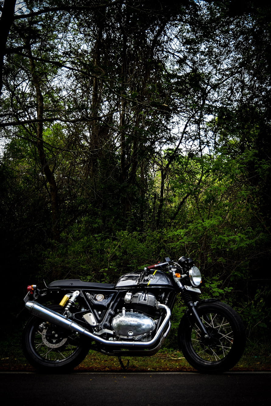 Royal Enfield Continental GT 650 Cafe Racer Parked in a Lush Forest Setting HD phone wallpaper