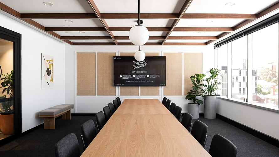 Modern Conference Room With Long Oak Table, Black Chairs, and Wall-Mounted Display HD wallpaper