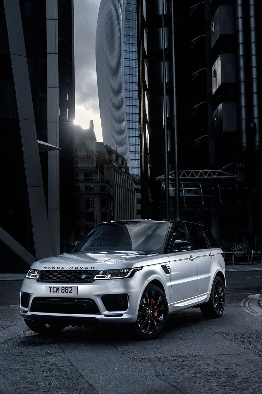 Silver Range Rover Sport HST parked on a city street with modern skyscrapers in the background HD phone wallpaper