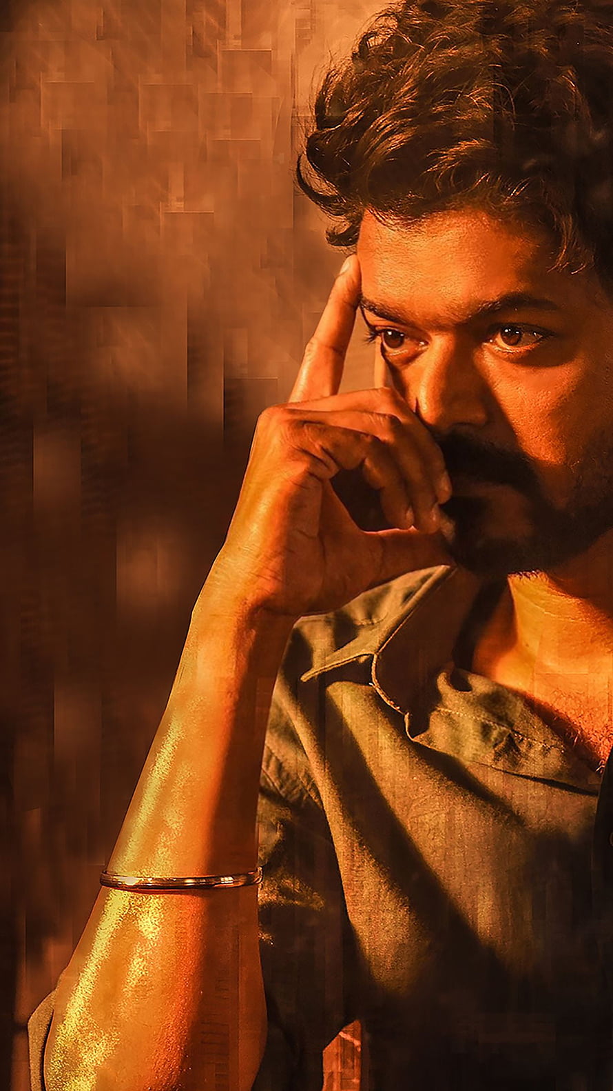 Vijay Thalapathy in a moody contemplative portrait with warm amber lighting HD phone wallpaper