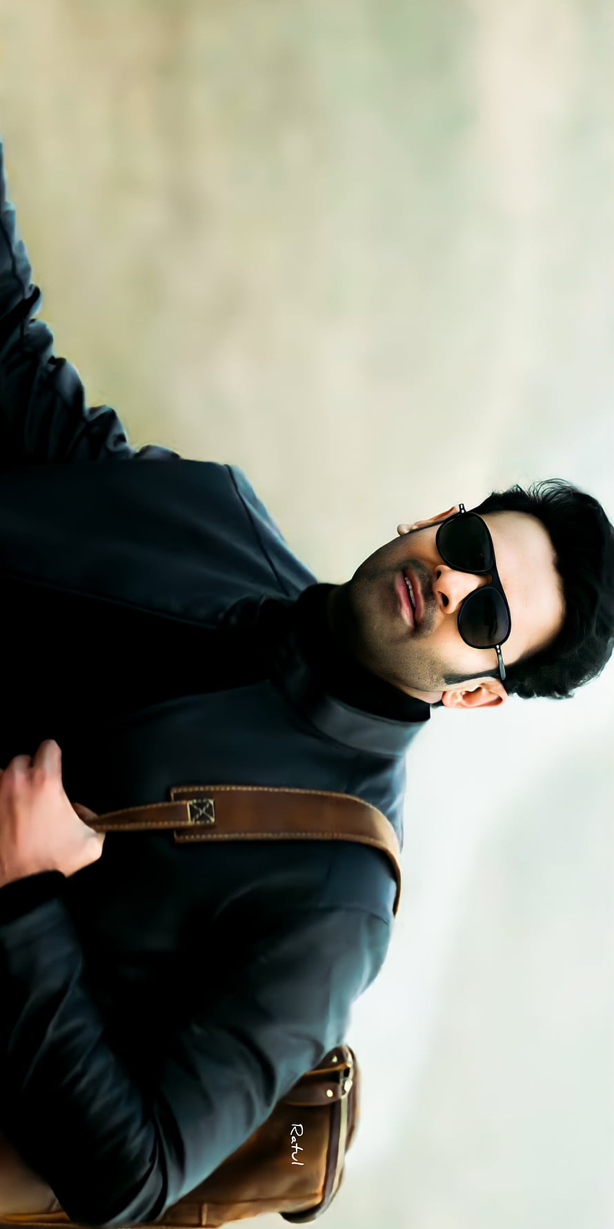 Prabhas in a black leather jacket and sunglasses with a brown messenger bag HD phone wallpaper