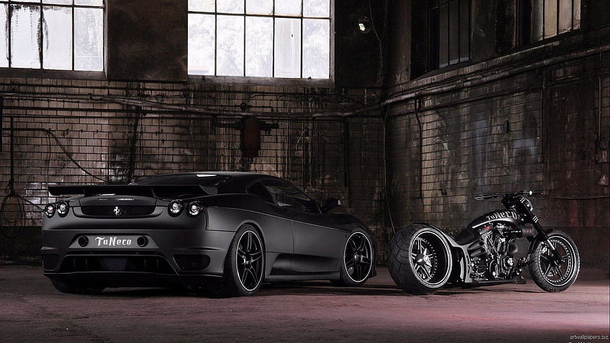 Matte Black Ferrari F430 and Custom Chopper Motorcycle in Industrial Warehouse HD wallpaper