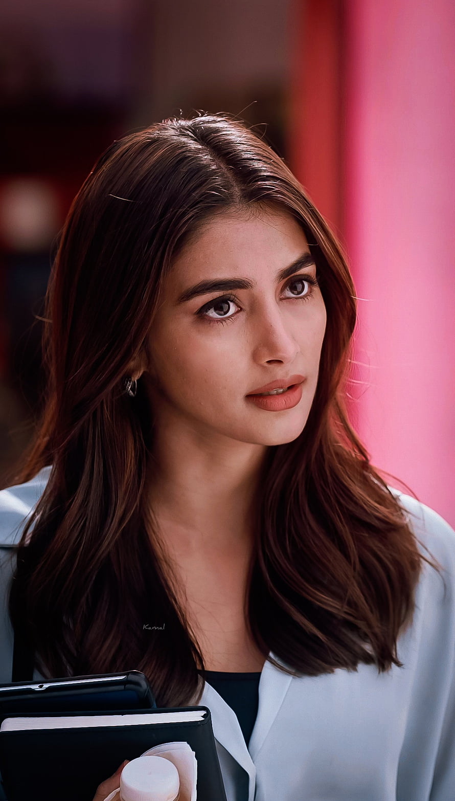 Pooja Hegde in a Light Blue Blazer Holding a Notebook Against a Pink Background HD phone wallpaper
