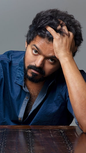 Thalapathy Vijay Intense Portrait in Blue Shirt with Hand on Head HD phone wallpaper